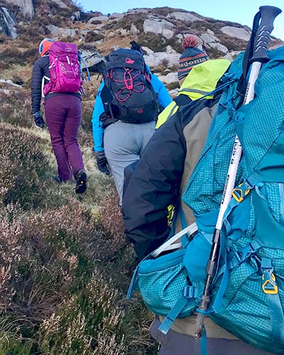 group hiking up hill